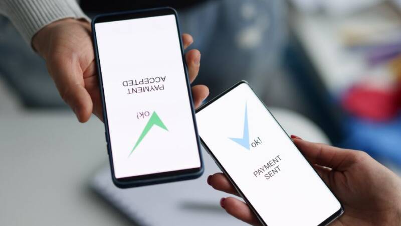 Two phones transferring instant payments in real time