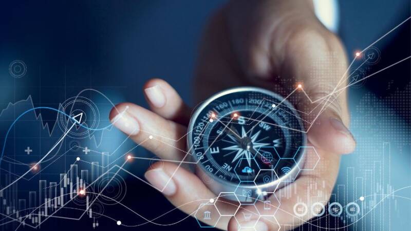 Male hand holding a compass