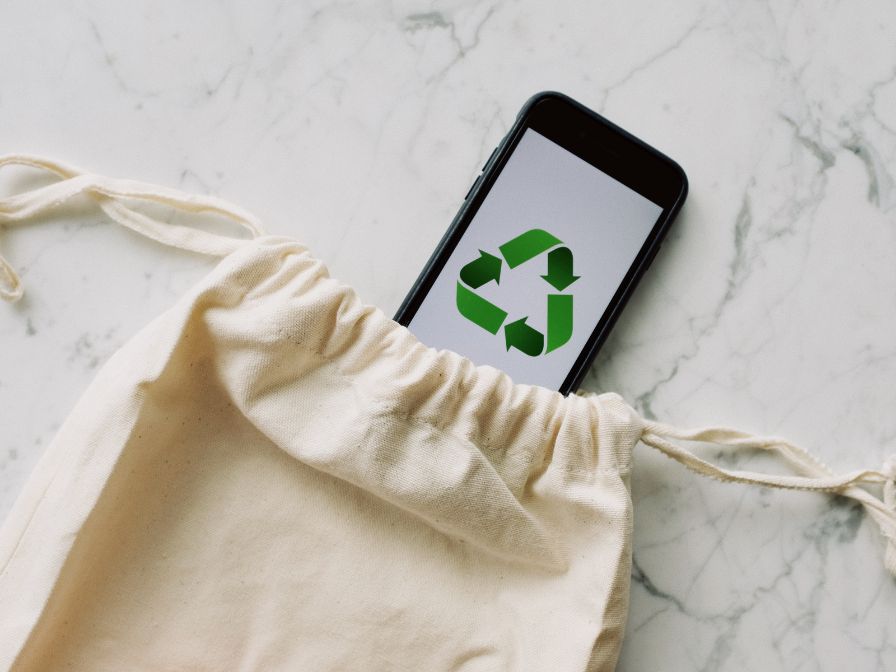 Cell phone with recycle symbol in sustainable pouch