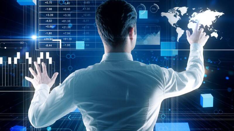 Man at touch screen computer with numbers and tech graphics