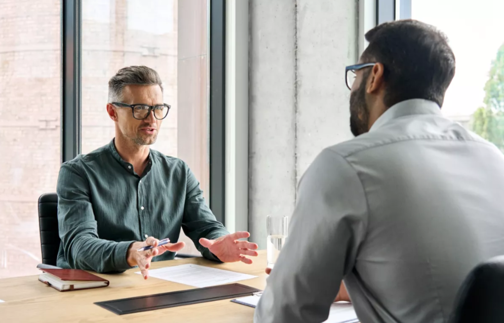 Banker talking to man at desk